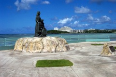Statue "The Women of The Island – Three Generations" honoring island women stands on Marine Corps Drive just South of Alupang Tower.